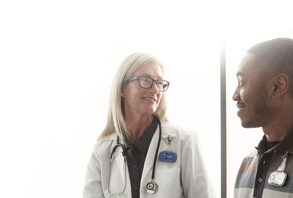 Doctor with glasses looking at patient