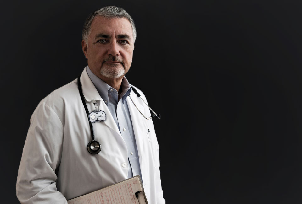 Doctor with clipboard on black background