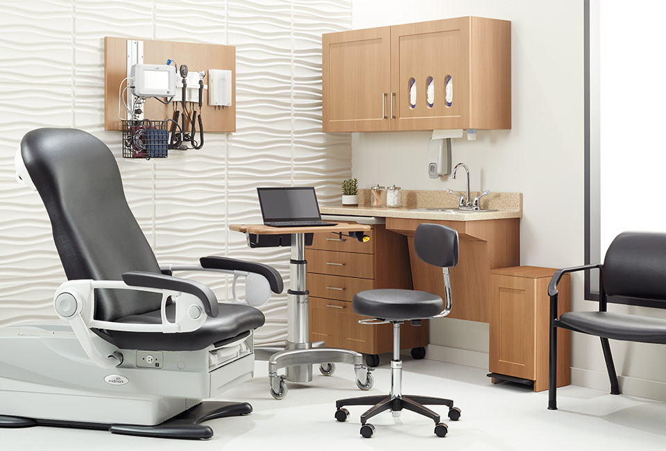 Exam room with Midmark exam chair, workstation, and medical cabinetry