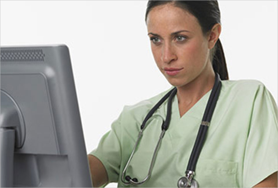 Nurse looking into workstation computer