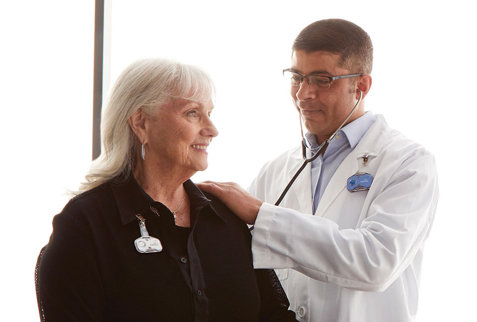 Doctor listening to patient with stethoscope