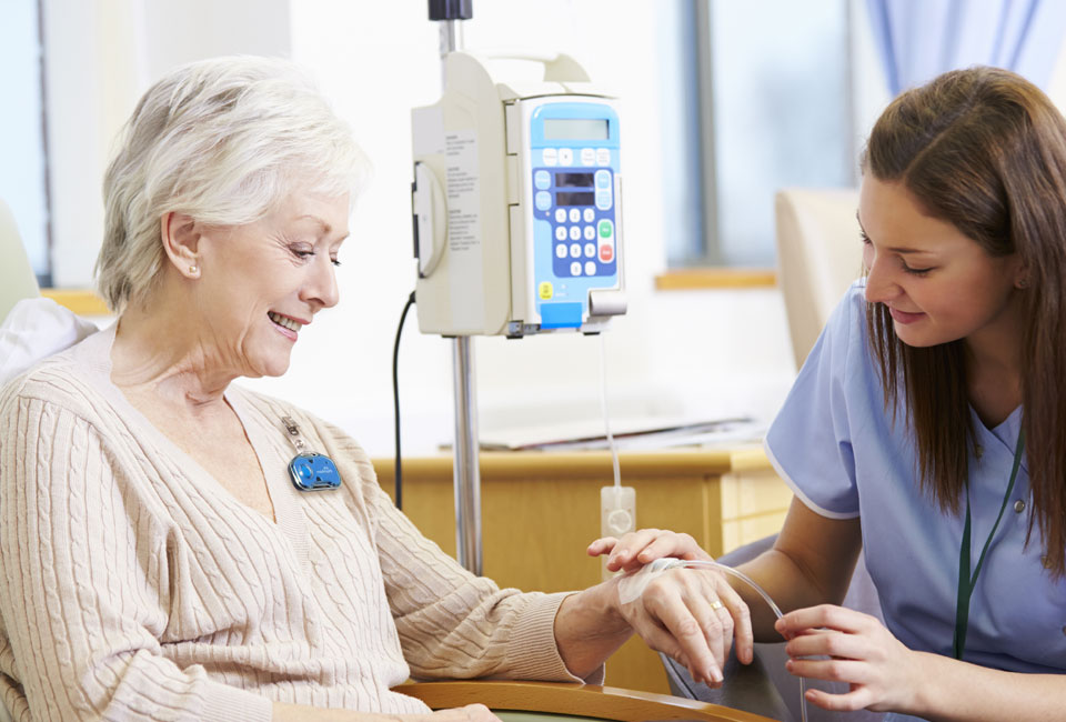 A nurse assisting a patient with an IV