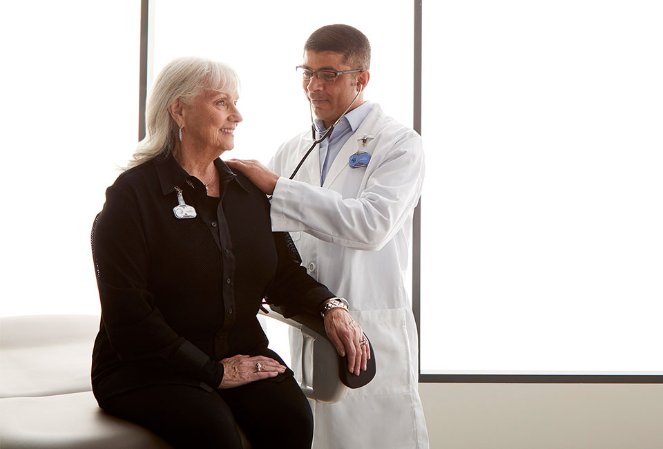 Doctor with patient listening in their stethoscope