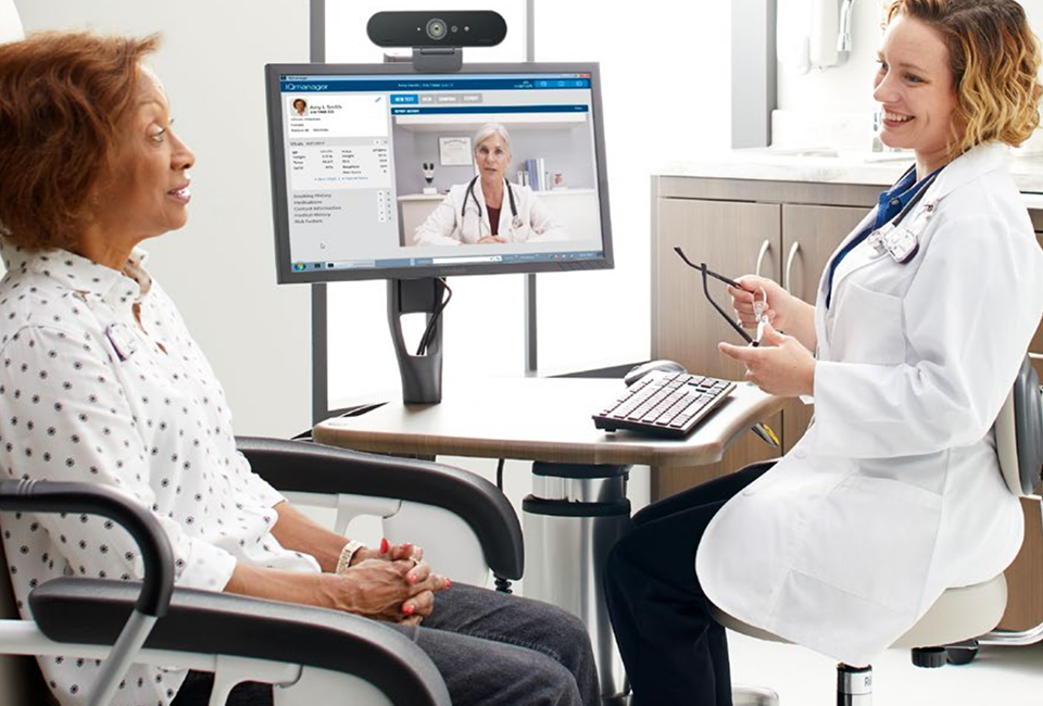 Doctor and patient in discussion with another doctor on a computer screen, consulting via telehealth