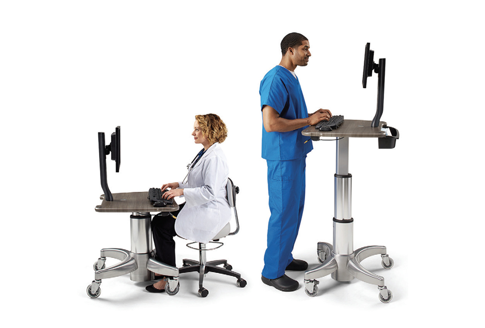 Doctor sat at Midmark mobile workstation, and a nurse standing at Midmark mobile workstation