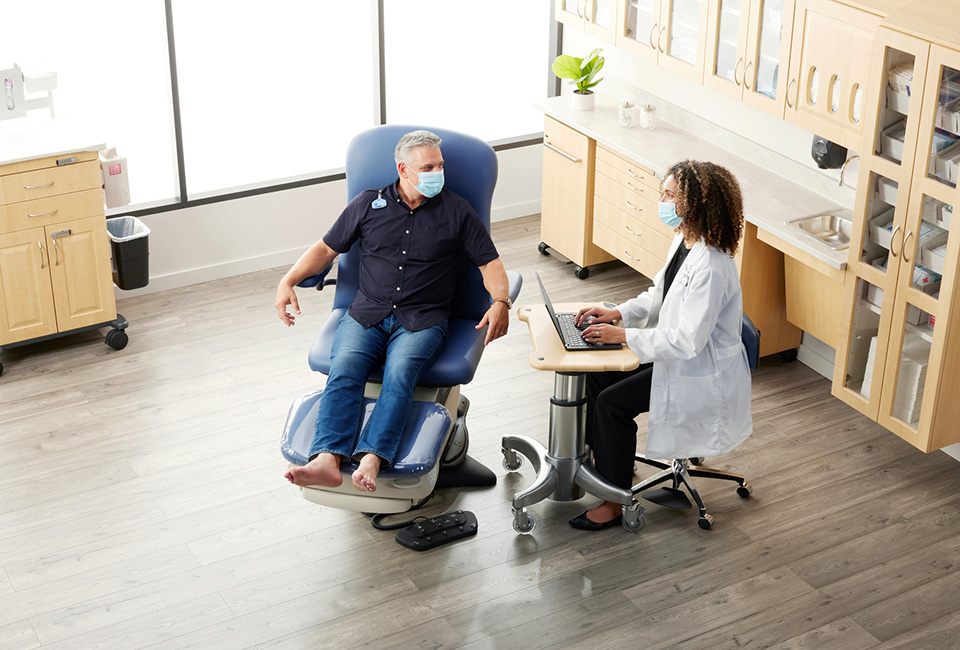 Doctor and podiatry patient in exam room