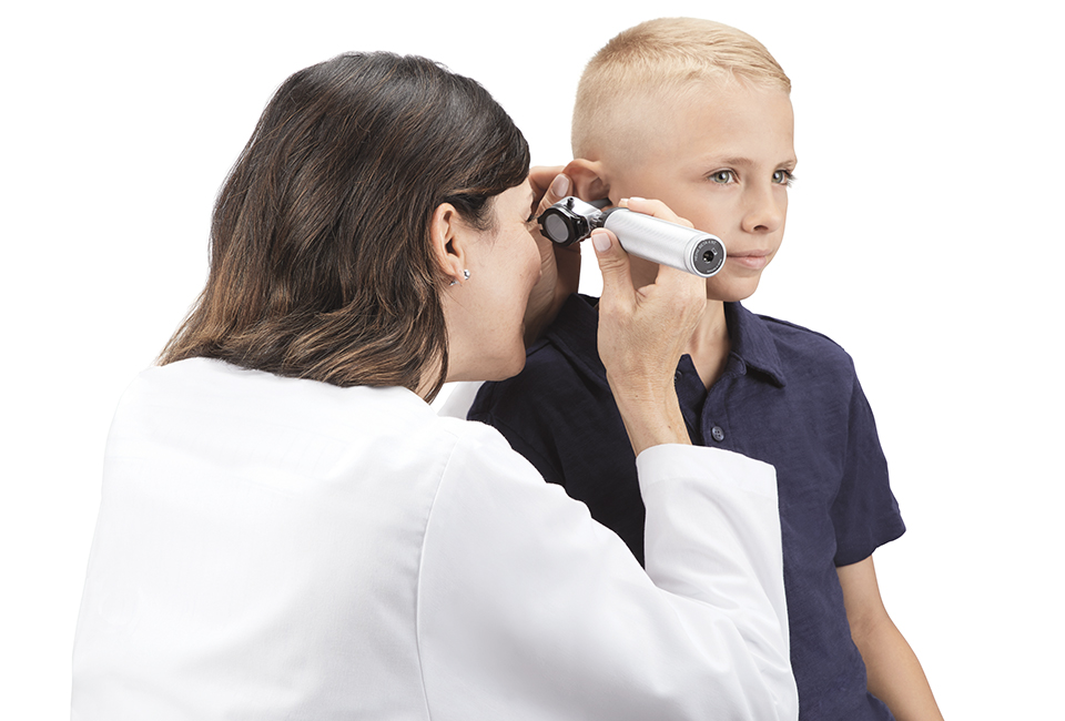 Doctor examining a young patient's ear