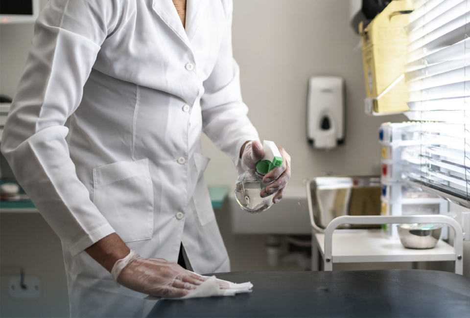 Medical staff sanitizing a surface