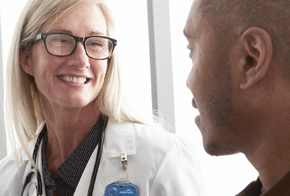 Female doctor smiling closely with a patient