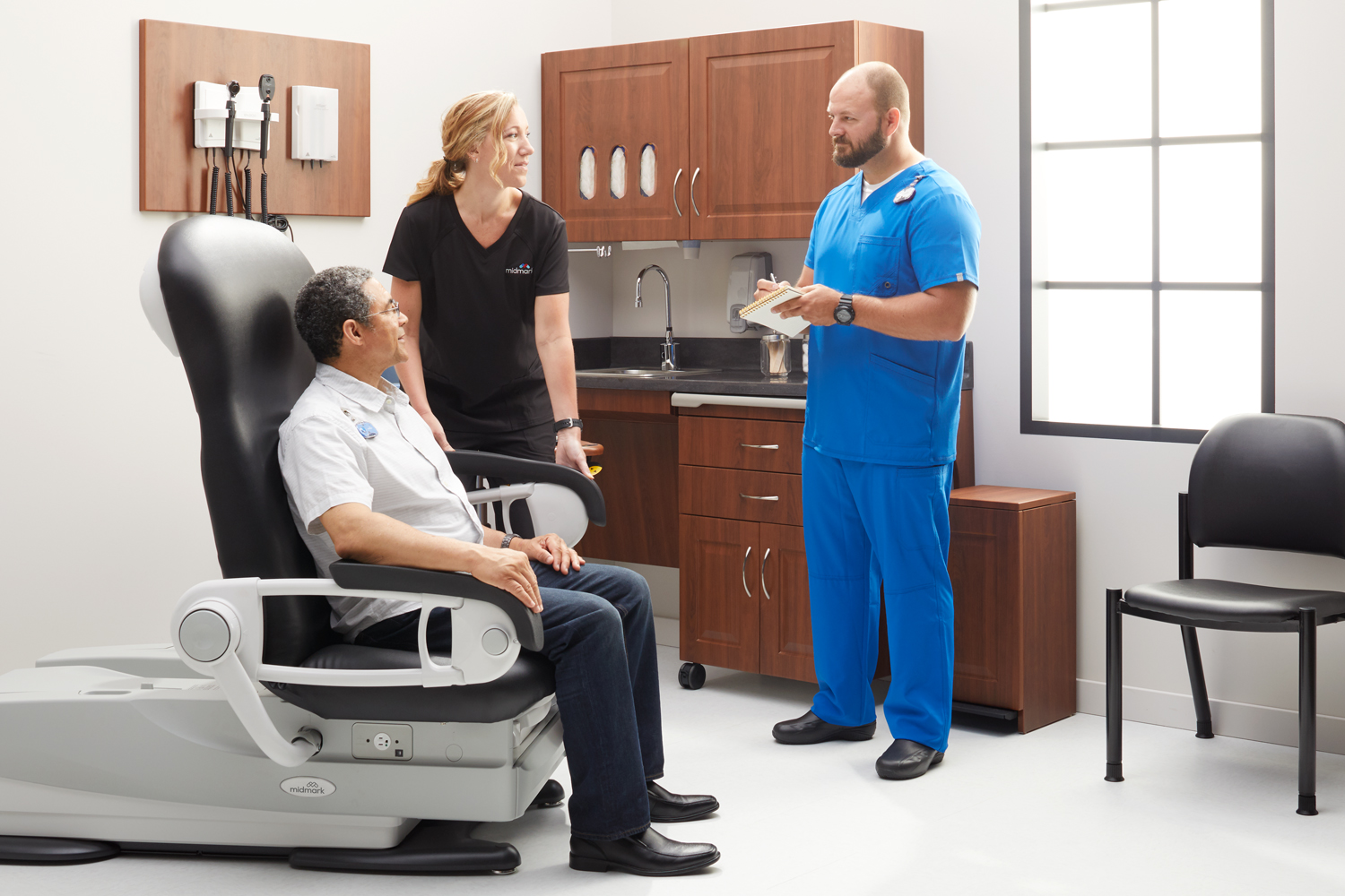 Nurses with patient in exam room