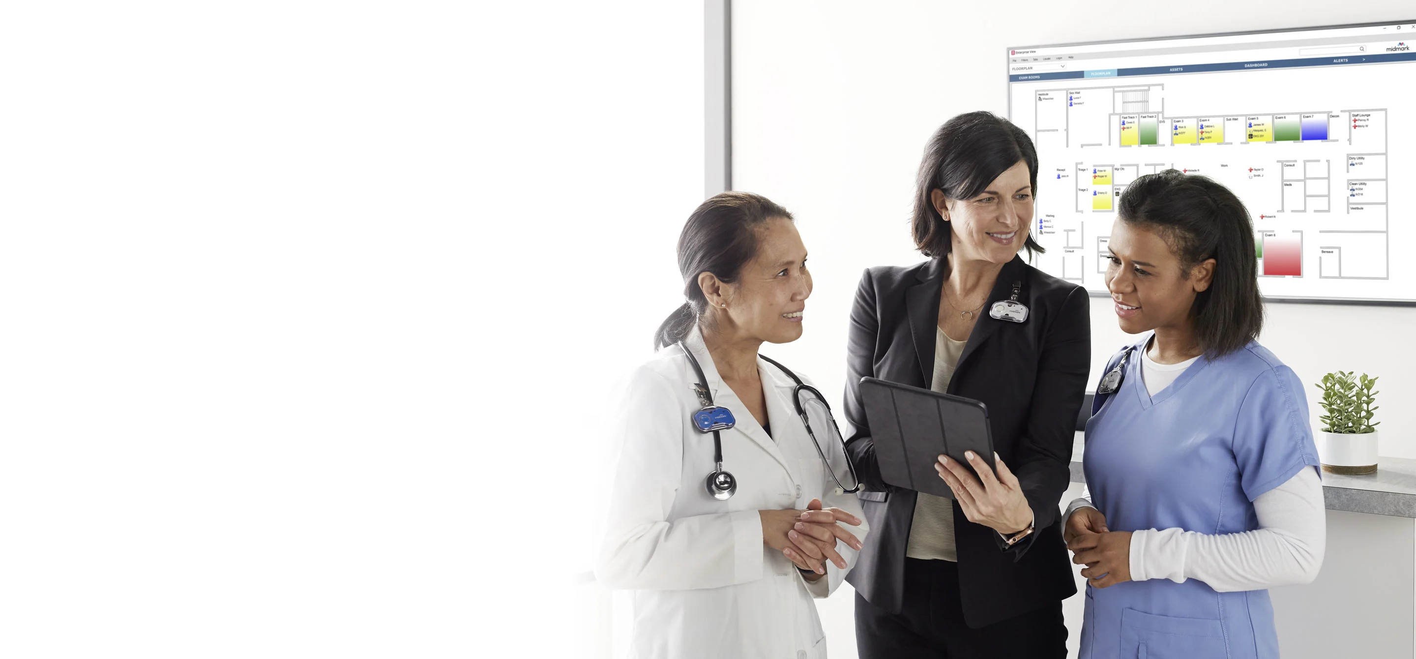 three doctors wearing midmark rtls badges and looking at a tablet